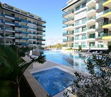 For Sale: Furnished 1+1 Apartment with Pool View, 100m from the Sea – Konak Seaside Resort,