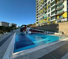 Furnished 1+1 apartment for sale. Panoramic mountain and nature views. Konak Garden Life